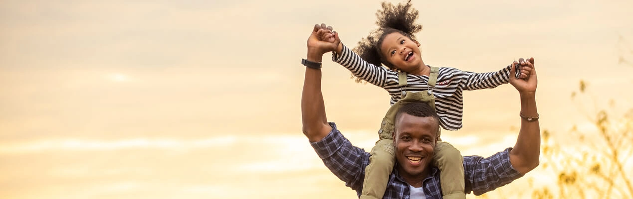 Father with daughter on shoulders