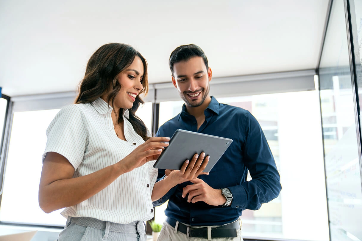 People looking at a tablet device