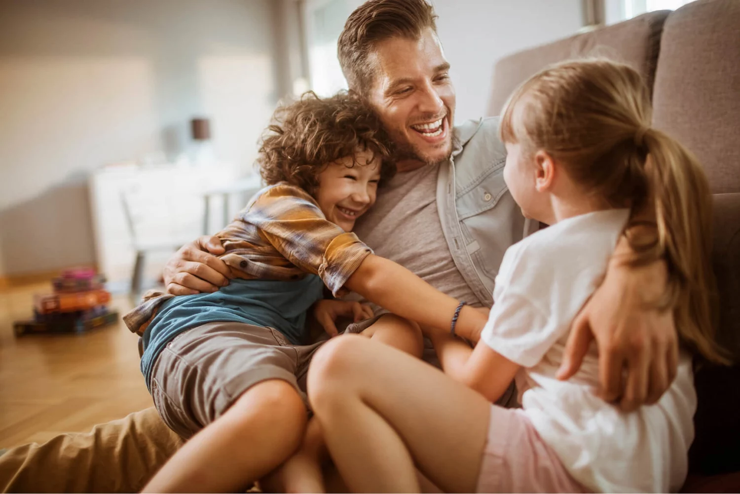 Family hugging on couch