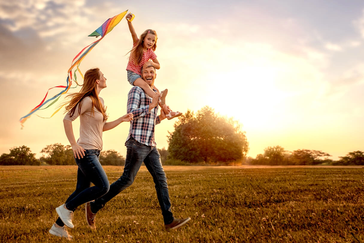 Family flying a kite in the park
